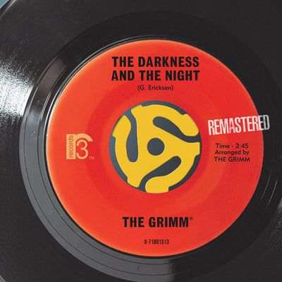 A close-up of a vinyl record label showing the text 'THE DARKNESS AND THE NIGHT', indicating the name of a song and an arranged by credit to 'THE GRIMM'. There is a 'REMMASTERED' stamp on the label, and the record company's name 'MCA' is visible.